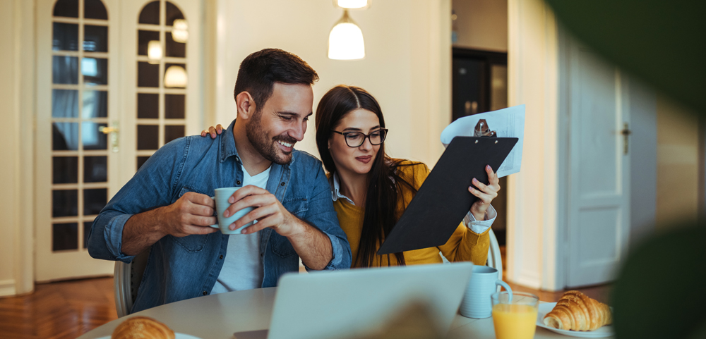 A couple lookingn at a clipboard