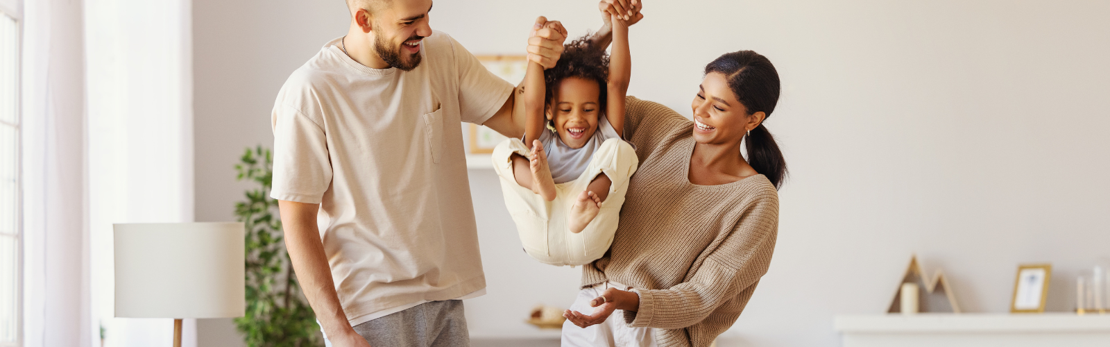 Mother, father, and child playing at home